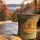Ceramic mug with Beechwood Inn logo on a wooden table, a plate of scones in the foreground, autumn trees and mountains in the background.
