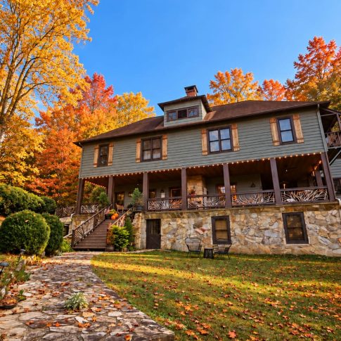 Stone garden path leading to Beechwood Inn beneath orange and gold autumn trees