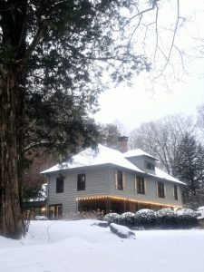 Beechwood Inn surrounded by snow-covered trees and a snowy lawn
