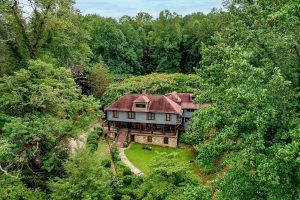 Aerial view of Beechwood Inn nestled among lush green summer trees